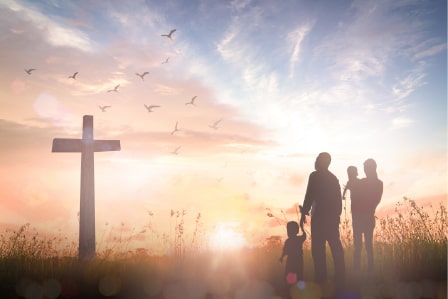A family looking at a cross
